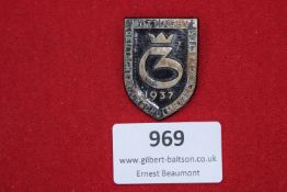 An enameled event badge for the 1937 German University Championships, held in Göttingen. Shield-
