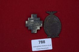 Two German Day Badges, comprising: a 1933 Stuttgart Turnfest cross and an oval 1938 commemorative