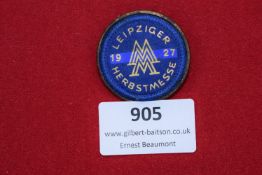 1927 Leipzig Autumn Fair Badge, circular form with blue and gold fabric insert, maker marked to