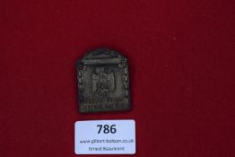 German pressed metal day badge, “Parole Heimat Reserve Hat Ruh”, eagle and swastika design