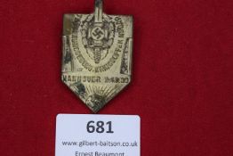 A pressed metal shield-shaped badge for the Treuebund Kriegsopfer (Veterans' Organisation) rally,