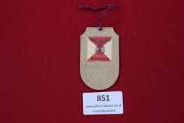 Kf.-Abt. 9 Unit Badge, aluminium, featuring staff car above eagle/swastika, pinback fixing.