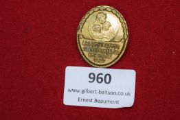 A gilt badge commemorating the Landestreffen der Kinderfreunde at Chemnitz, 1927. Oval form with