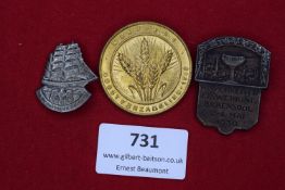 Three German/Nazi-era Day Badges: one in silvered metal, ship motif with eagle and swastika, for Tag