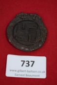Early Swastika Wreath Badge, bronze pressed-metal circular badge with large swastika to centre