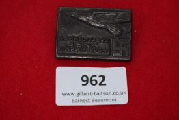 SA Brigade 42 Rally Tinnie, a rectangular pressed badge depicting a flying eagle with swastika,
