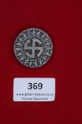 German Day Badge, c.1930s, a circular zinc badge featuring a central sun-wheel swastika within a