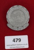 NS-Volkswohlfahrt Day Badge, Kassel 21.4.1935, a circular grey alloy badge depicting cityscape