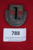 Westfälische Oktober Messe Badge 1933, pressed-metal shield-shaped badge enamelled in red, black and