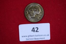 Skull Badge, a circular bronze badge with raised Totenkopf skull and crossbones motif.