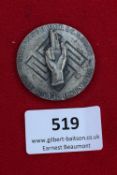 Treueschwur Badge, 1934, a circular silvered badge with raised right hand motif over swastika,