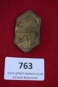 Bergturnfest Badge 1930, a bronze-coloured pressed-metal hexagonal badge depicting athlete