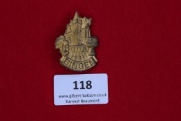 Bingen Day Badge, a gilt pressed-tin event badge depicting castle towers above grape motif,