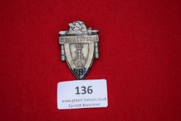 Regimental Day Badge, 1922, a shield-shaped white-metal badge with oak leaves and helmet,