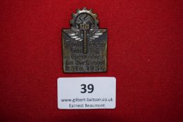 Trade and Commerce Rally Badge, Cologne 1934, a bronze alloy badge surmounted by cogwheel and