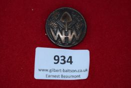 WHW 1935–1936 Winterhilfswerk Badge, a circular pressed-brown badge featuring shovel, wheat, and