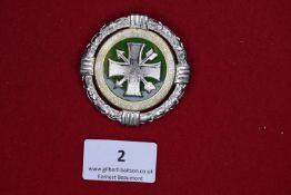 St. Sebastianus Schützenbund Badge, a circular silvered and enamelled badge with oakleaf wreath