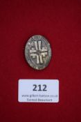 Turnfest Badge, oval silvered example with central cross and swastika, inscribed 