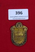 Motorsturm 2/62 Lingen Badge, 1933, a pressed gilt metal badge with scrolled shoulders, surmounted