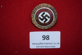 Enamelled NSDAP Golden Party Badge, circular gilt wreath surround, red enamel band with “National-