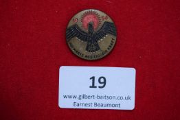 Aufwärts aus eigener Kraft Badge, 1934, a circular bronze-coloured and enamelled pressed badge,