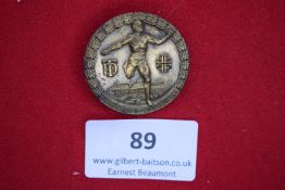 Bronze tinnie badge, “Bergfestlauf der Augustusburg”, depicting athlete running, castle below.