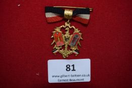Commemorative Medal with Ribbon, a gilt and enamel badge suspended from black-white-red bow,