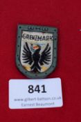 WHW “Grenzmark” Badge, a rectangular pressed-tin badge with green frame and woven insert depicting a