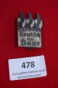 “Deutsch die Saar” Badge, a rectangular cast badge with stylised flames and battlement design