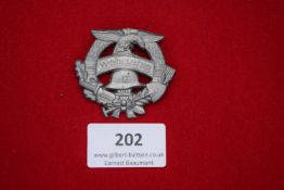 Wehrfähig Badge, grey metal badge with German eagle, helmet, crossed weapons and banner.