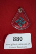 Swastika Pendant, a clear plastic pendant with suspended blue enamelled swastika, loop for