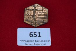 Austrian Political Badge, a hexagonal bronze badge depicting a stylised male figure with