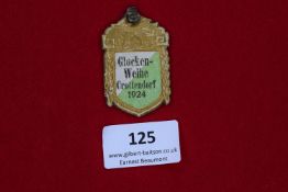 Glockenweihe Crottendorf 1924 Badge, a shield-shaped pressed card badge with gilt border and green