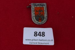 Wenden Badge, a pressed-tin shield badge with enamelled-style depiction of warrior figure, Wenden