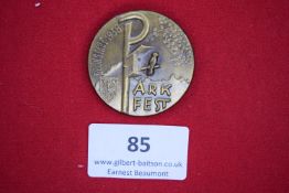 Sudeten Day Badge, 1937, a circular gilt badge depicting two male heads in profile, swastika to