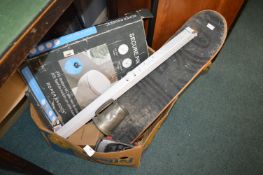 Box of Assorted Items Including a Skateboard