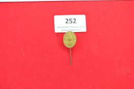 Brass Stickpin Badge “DLW” – An oval brass stickpin badge with raised laurel wreath border enclosing