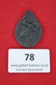 A German Third Reich Labour Day Badge, 1934, blackened pressed card issue with symbolic worker