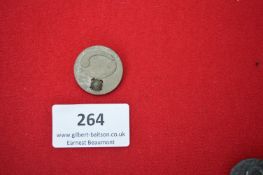 Circular Metal Commemorative Badge “Juli” – A pressed metal circular badge with raised fasces design