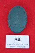 A German trade fair commemorative badge, oval green pressed bakelite issue with allegorical female