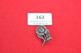 A German Third Reich Tinnie badge in the form of a rose, variant pattern to the preceding, die-