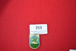 Enamelled Commemorative Tinnie Badge “Deutsche Bergwacht” – A shield-shaped pressed tin badge with