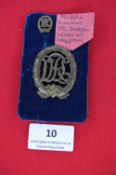 A German WWII DRL sports badge in bronze, large size with swastika to base, together with a