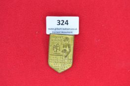 NSV Tinnie – “Mutter u. Kind”, shield-shaped brass badge, depicts mother with child and NSV