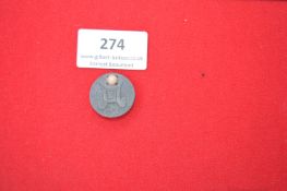 A German WWII-era membership badge, zinc construction. Reverse marked with date and maker’s code.