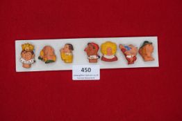 A German WWII WHW set of painted ceramic character head badges, caricature and folk figures