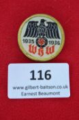 A German Winterhilfswerk (WHW) badge, circular fabric issue for 1935–1936, bearing black national