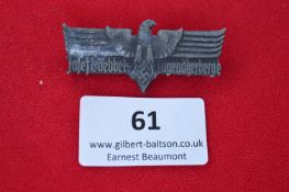 A German Third Reich Commemorative Badge, grey alloy issue, spread eagle with swastika, inscribed