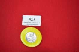 Plastic Fundraising Badge with Religious Medallic Insert – A circular yellow plastic badge with