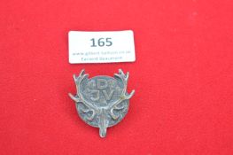 A German hunting association badge, the circular face with antler and skull design framing the